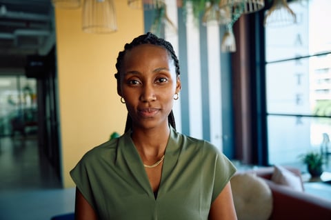 Confident black businesswoman standing in modern office